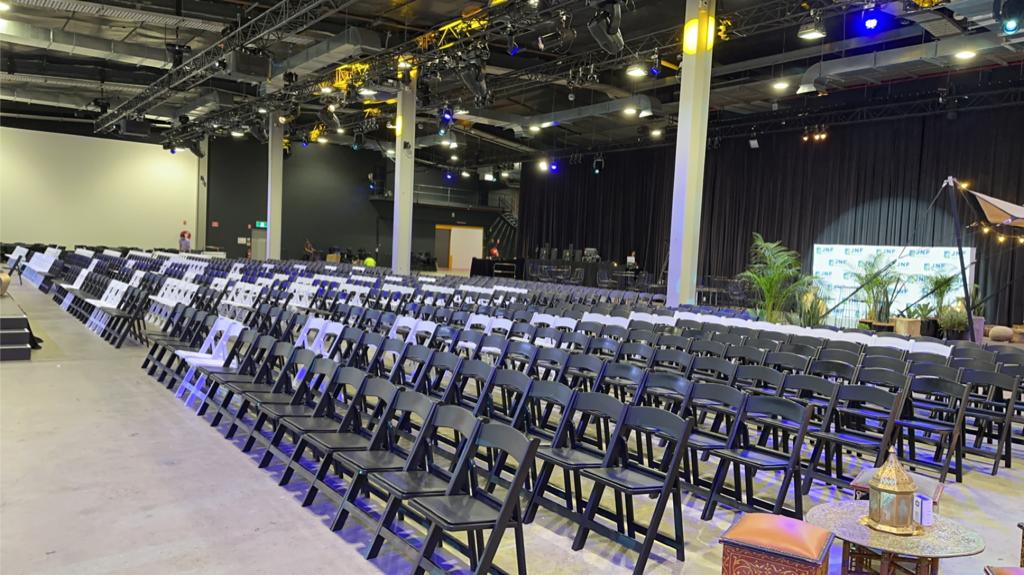 black padded folding chairs at a venue