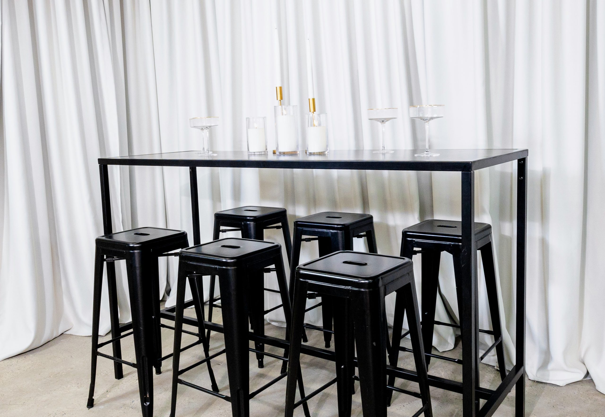 black cocktail bar stool and black rectangular tapas table