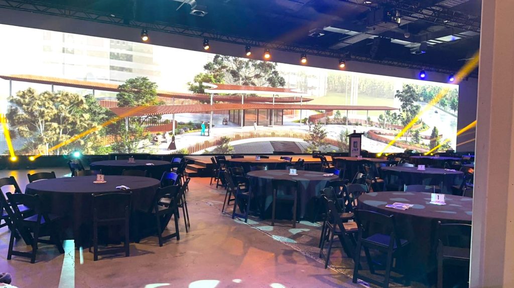 black round banquet table with black padded folding chairs