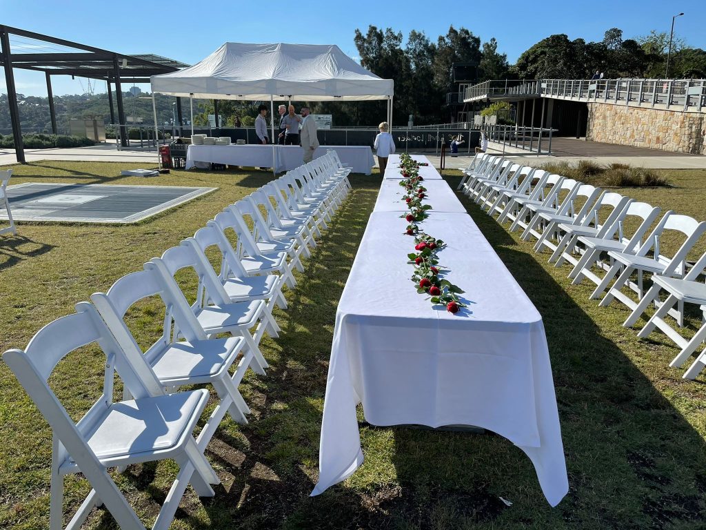 white padded folding chair and plastic table