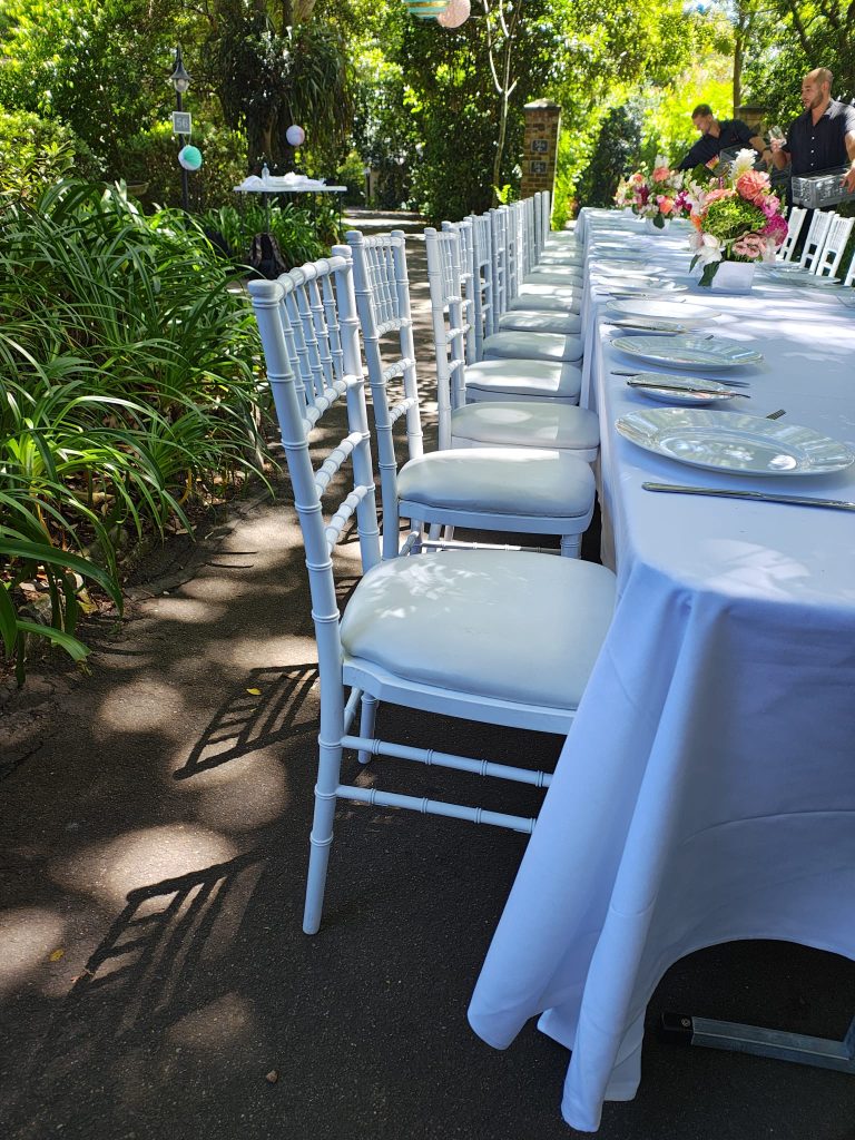close up white tiffany chair setup garden party