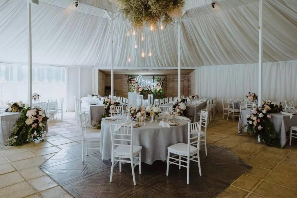 Wedding reception with white decor and white chair hire