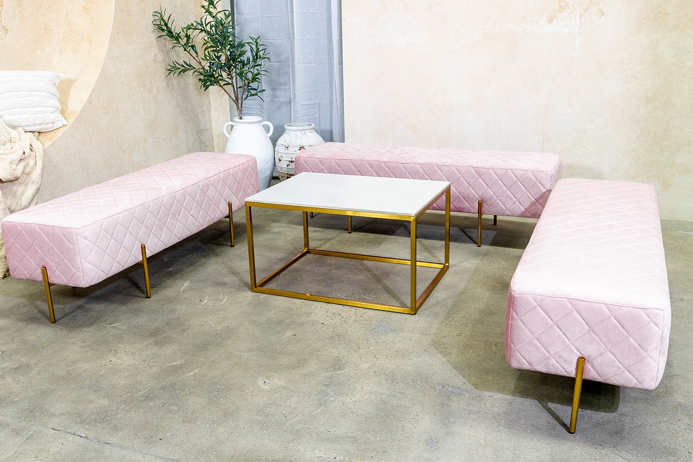 pink velvet ottoman benches paired with gold coffee table