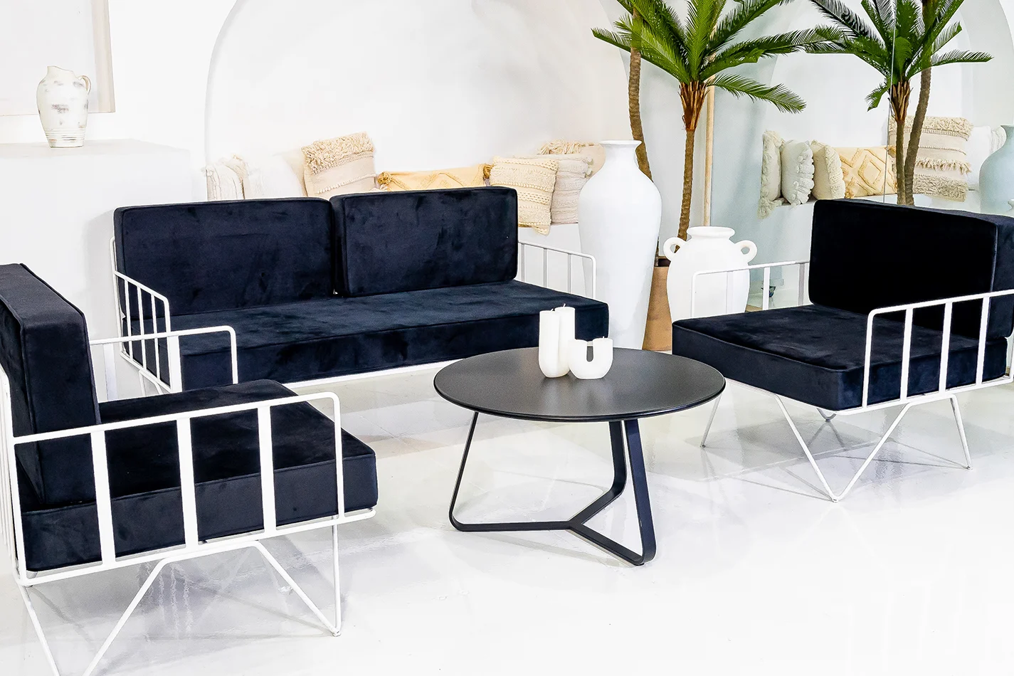lounge set up for white wire velvet lounge with black cushions and a black coffee table