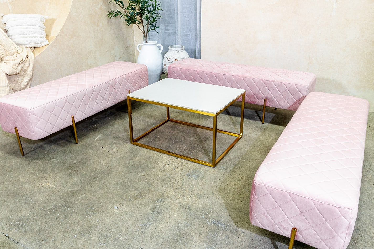 pink velvet ottoman benches paired with gold coffee table