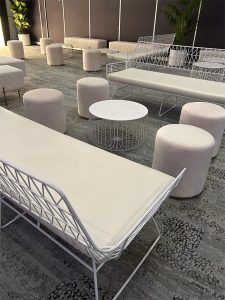 lounge setup of white arrow lounge hire, ottoman stools and coffee table