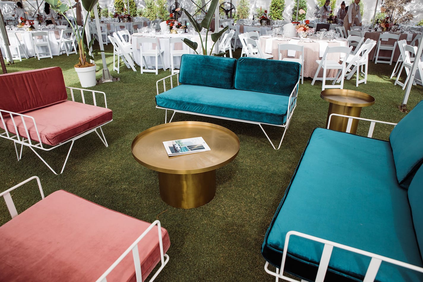 outdoor lounge setup with emerald green sofa lounge and pink lounges