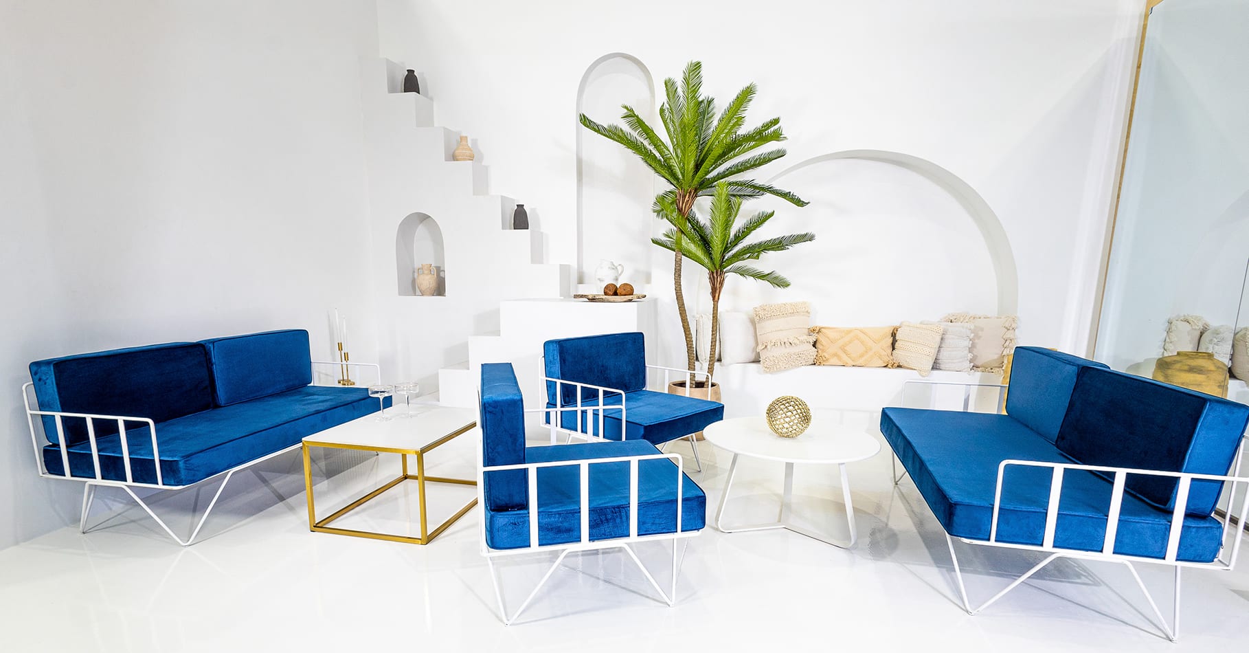 lounge setup with navy blue sofa lounge and arm chairs